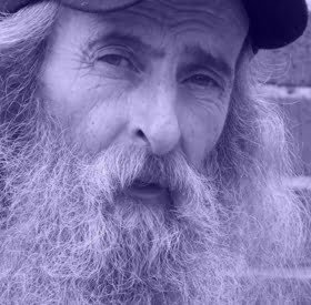 Older man with beard and hat close-up.