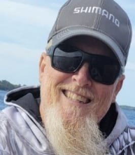 Man with sunglasses smiling outdoors