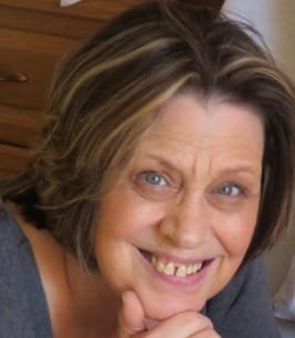 Smiling woman with short hair and striped highlights