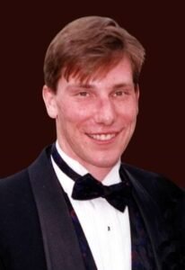 Man in tuxedo smiling at the camera