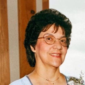 Smiling woman with glasses indoors