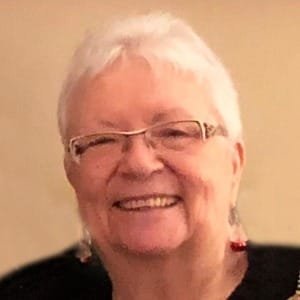 Elderly woman smiling with glasses