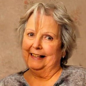Smiling elderly woman with short gray hair