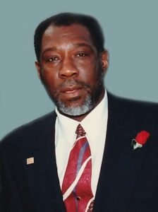 Man in suit with rose on lapel.