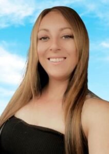 Smiling woman with long hair, blue sky background