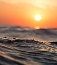 Ocean waves at sunset with colorful sky