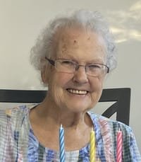 Elderly woman smiling with birthday candles