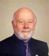 Portrait of an elderly man with a beard.