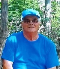 Person in blue shirt outdoors