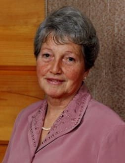 Smiling elderly woman in pink blouse