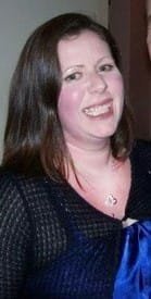 Smiling person in formal attire at an event