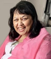 Smiling woman in a pink shawl.