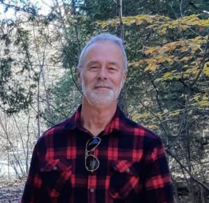 Man in plaid shirt in forest