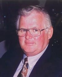 Portrait of an elderly man with glasses, suit.
