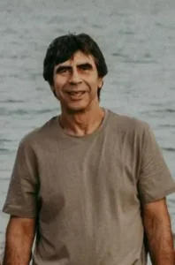 Smiling man standing by the water