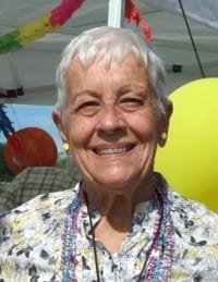 Smiling elderly woman at outdoor celebration