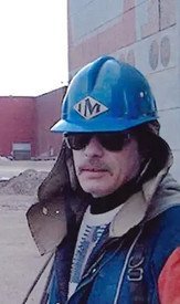 Construction worker wearing blue helmet outdoors