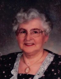 Elderly woman smiling portrait with lace collar.