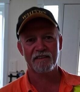Man wearing baseball cap indoors