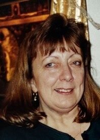 Smiling woman with brown hair indoors