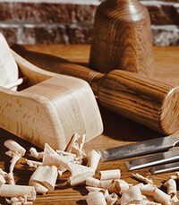 Woodworking tools and shavings on workbench.