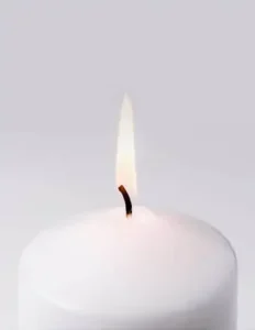 White candle with flame burning