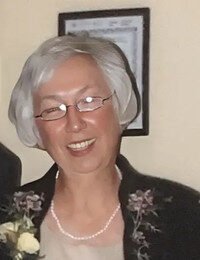 Smiling elderly woman with glasses and white hair