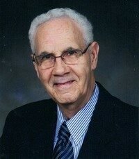 Elderly man in suit and tie smiling