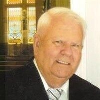 Elderly man smiling in a suit and tie