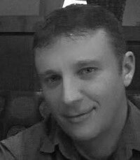 Black-and-white portrait of a smiling person