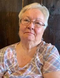 Smiling elderly woman in plaid shirt