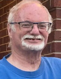 Smiling man with glasses and beard.