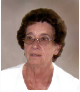Elderly woman wearing glasses and white shirt