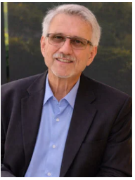 Smiling man wearing glasses and a suit