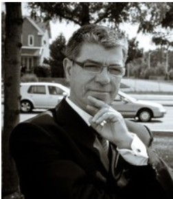 Man in suit posing outdoors near street