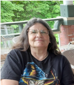 Person sitting on porch with wizard cat shirt