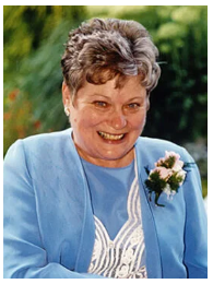 Smiling woman in blue suit with corsage