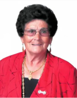 Smiling woman in red blazer with glasses