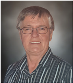 Smiling person wearing glasses, striped shirt portrait