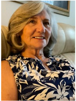 Smiling older woman sitting on beige couch
