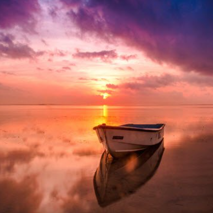Boat on sunset reflective water landscape