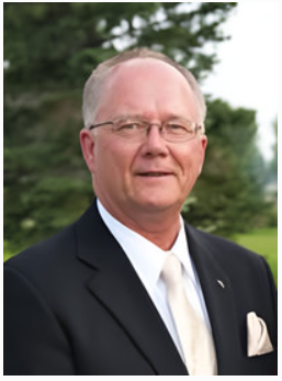Man in suit with trees in background