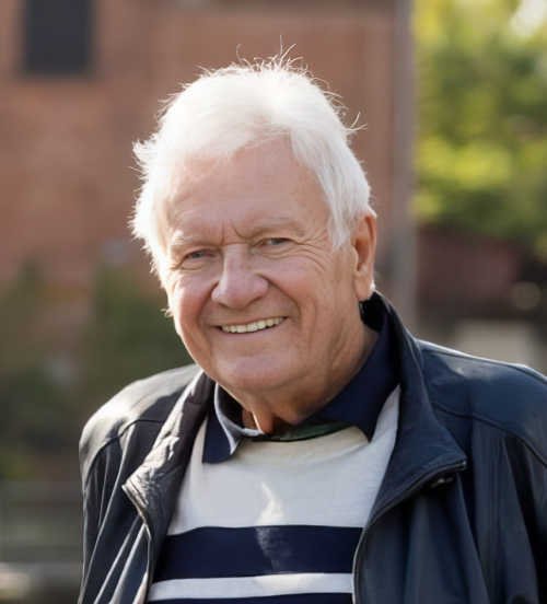 Smiling older man in outdoor setting.