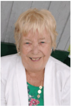Smiling person in white jacket and floral top