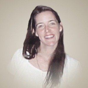 Smiling woman with long hair in white shirt