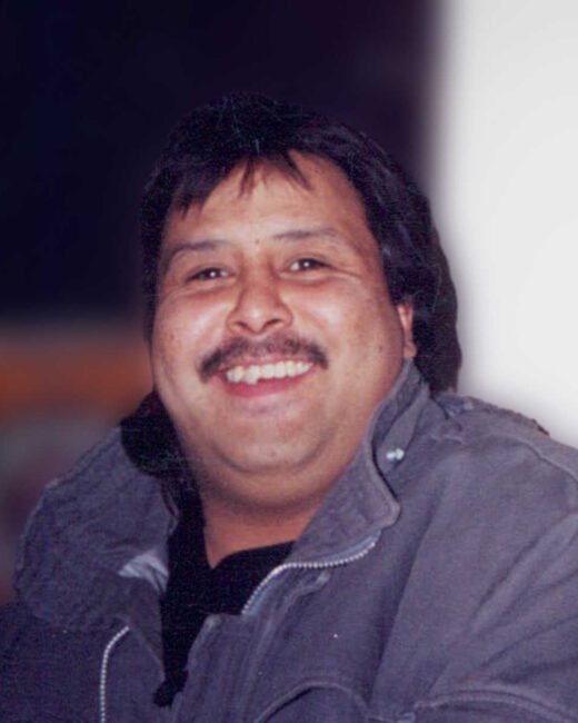 Smiling person in winter coat indoors.