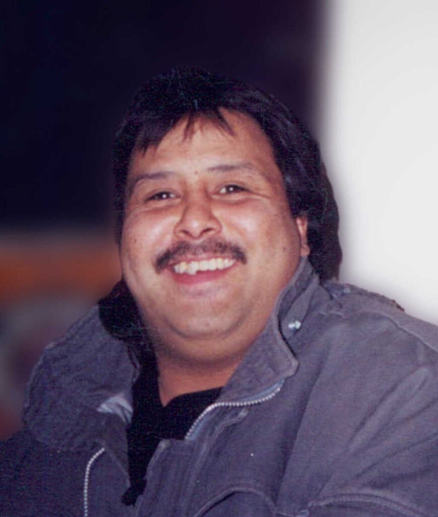 Smiling person in winter coat indoors.