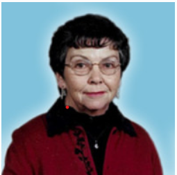 Woman with glasses and short dark hair smiling.