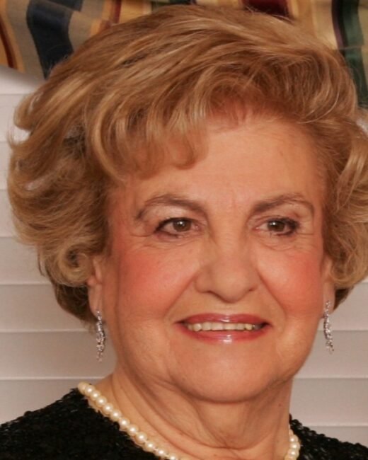 Elderly woman smiling with pearl necklace