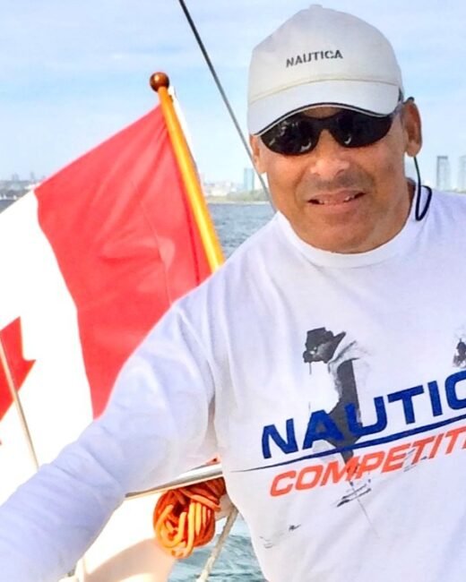 Man sailing with Canadian flag on boat